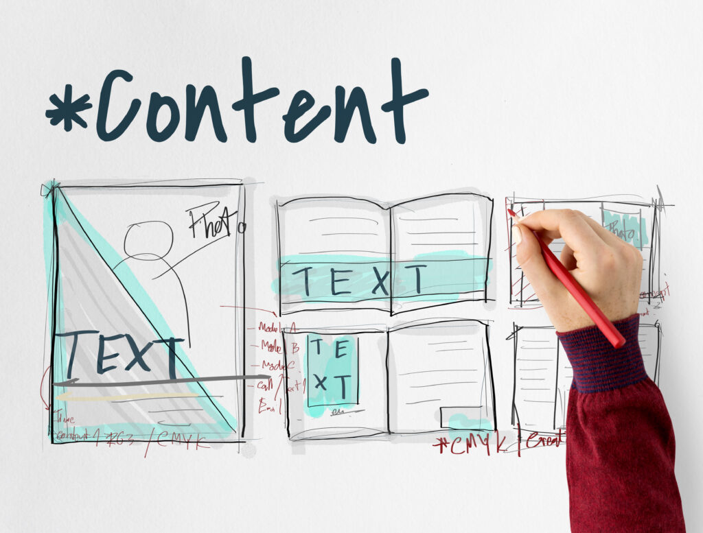Hand drawing a layout with a red pencil, showing mocked-up book pages and text boxes. The word "Content" is written prominently above.