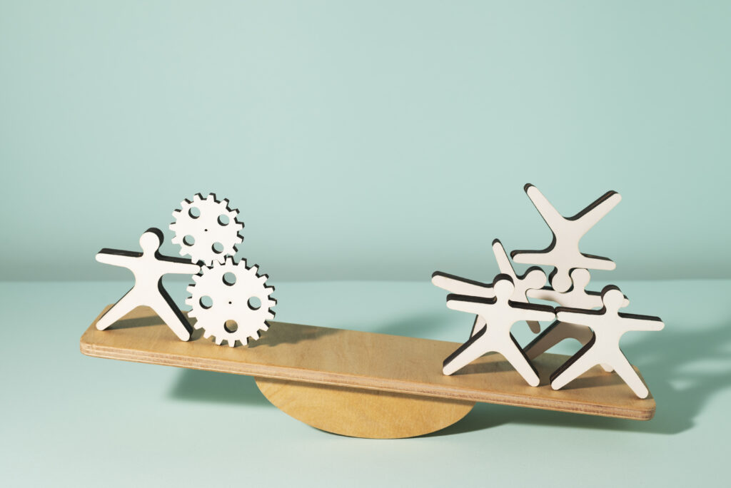 Visual metaphor showing the balance between product development and marketing in startups with gears on one side and a team collaboration on the other